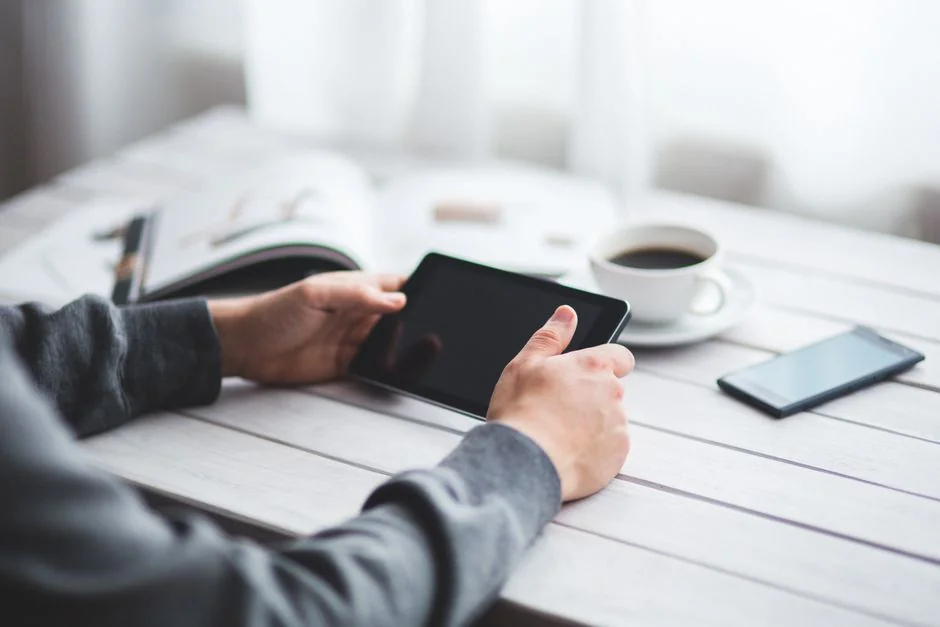 who-we-are A person using a laptop to browse stock photo websites. Freelancing work in a cozy setting.